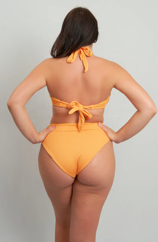 Back view of woman in textured ribbed orange high-waisted bikini set showing halter neck and back tie closures for adjustable fit